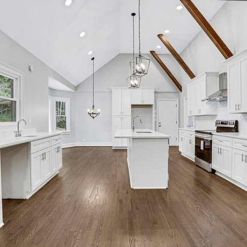 Hardwood flooring in an open concept kitchen by Marquis Floors in Lilburn, GA